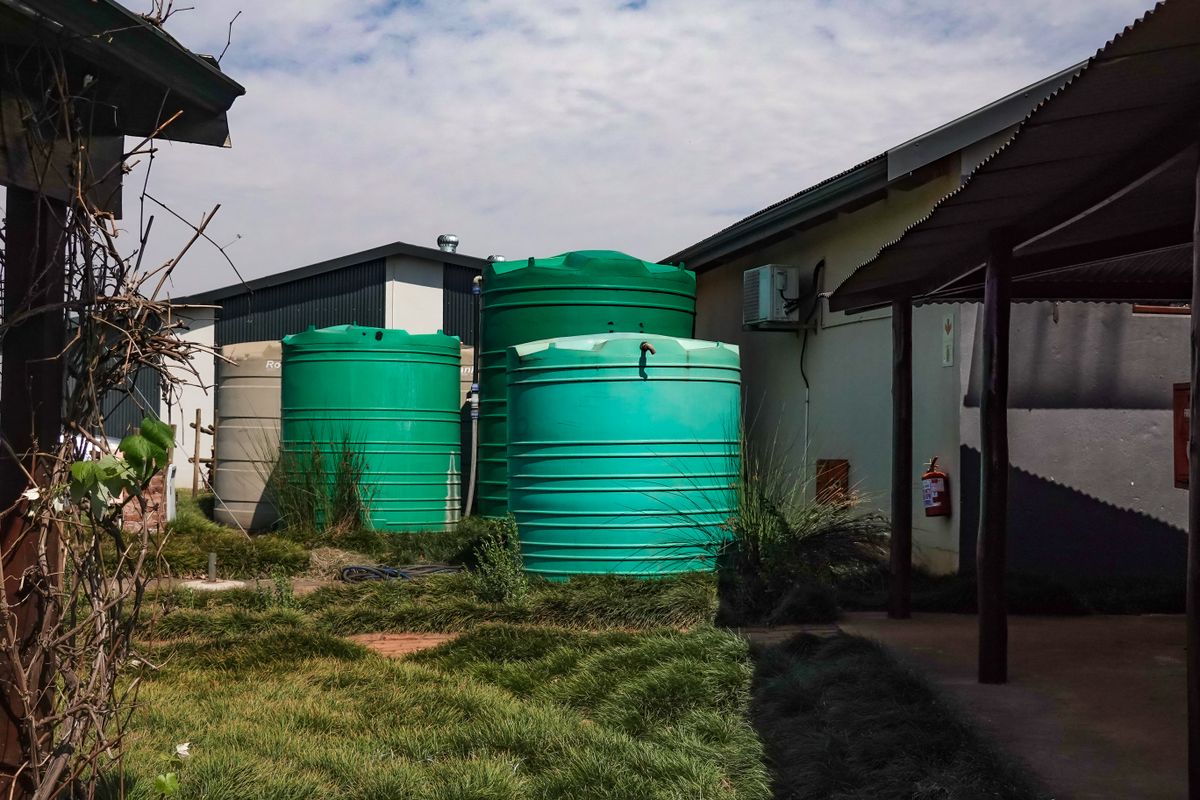 Water storage tanks beside a building for rainwater harvesting
